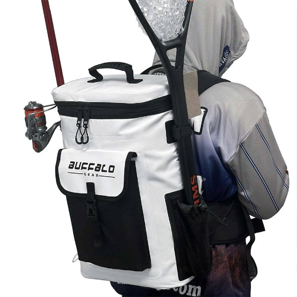 White and black cooler bag with fishing rod and tackle, attached to a backpack on a person.