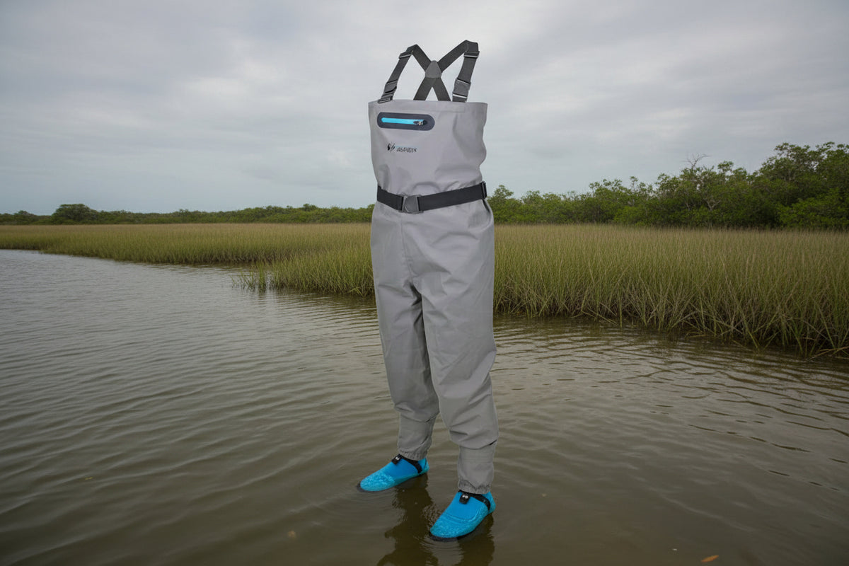 Gray waterproof waders with blue booties and black suspenders.