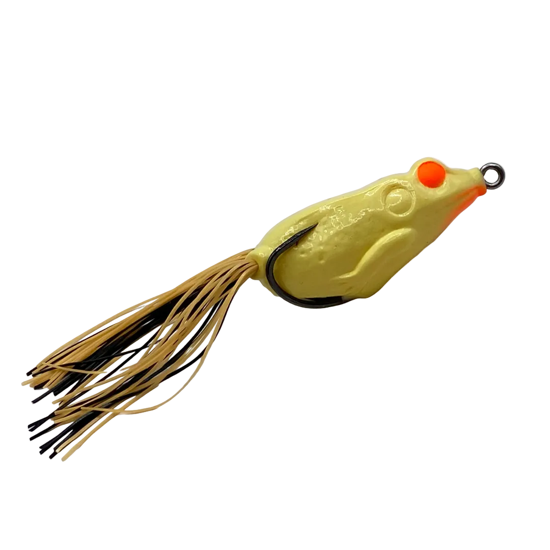 A frog-shaped fishing lure with a textured yellow body, bright orange eyes, and a skirt made of tan and black strands, shown on a plain white background.