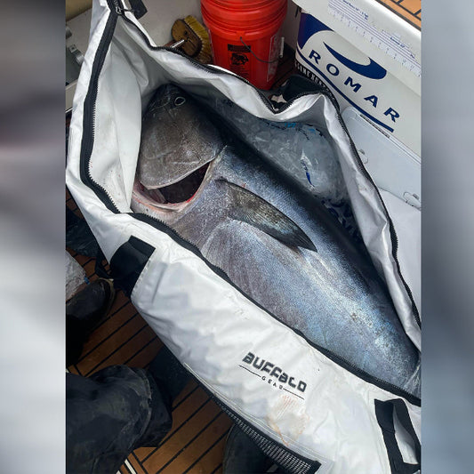 Open cooler bag with fish inside, labeled 'Buffalo Seafoods', on a boat deck.