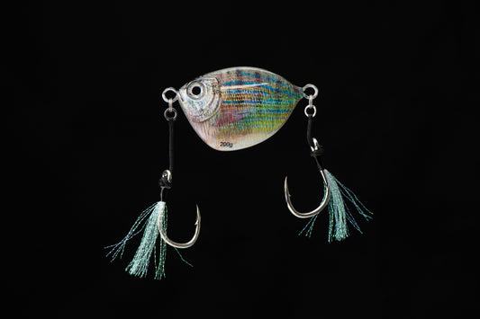 Fishing lure with a colorful body and black hooks on a black background
