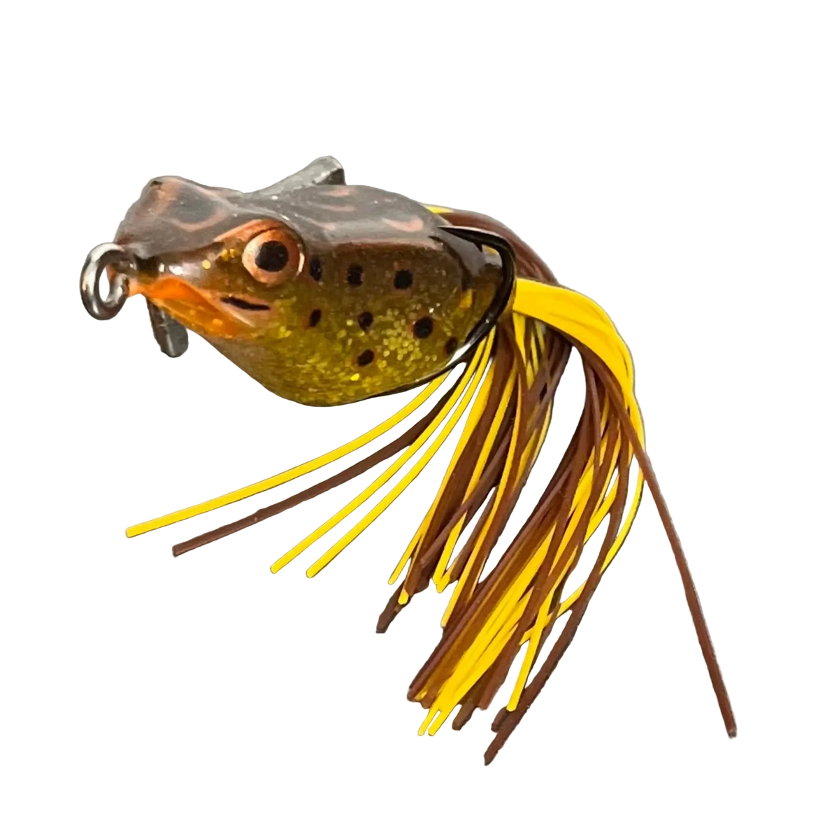 A frog-shaped fishing lure with a realistic head, featuring a yellow and brown skirt with dark brown and yellow strands, photographed on a neutral gray background.