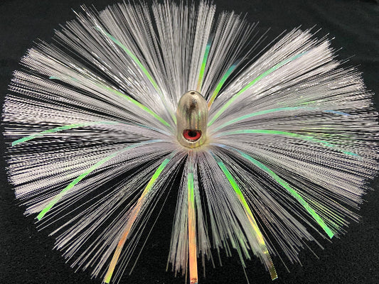 Close-up of a fishing lure with white and green fibers on a black background