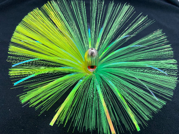 Fishing lure with green and yellow fibers on a black background