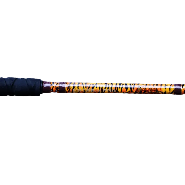 A close-up of a fishing rod blank showing a black textured handle grip and a glossy shaft with a yellow, orange, and black tiger-stripe pattern, set against a solid white background.