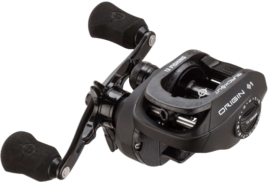 13 Fishing Origin 1 baitcasting fishing reel with black handle grips and black body, featuring white brand text on a white background.