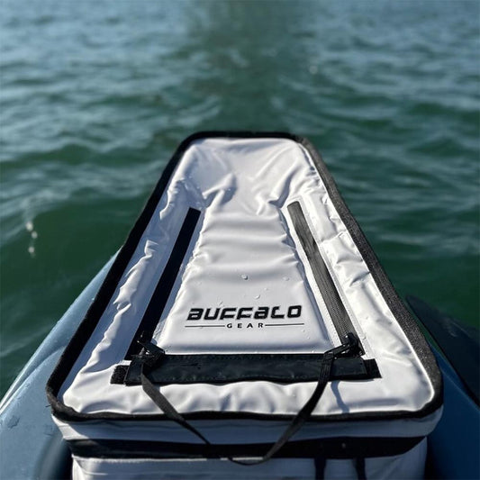 White cooler bag with black straps on a boat, water in the background