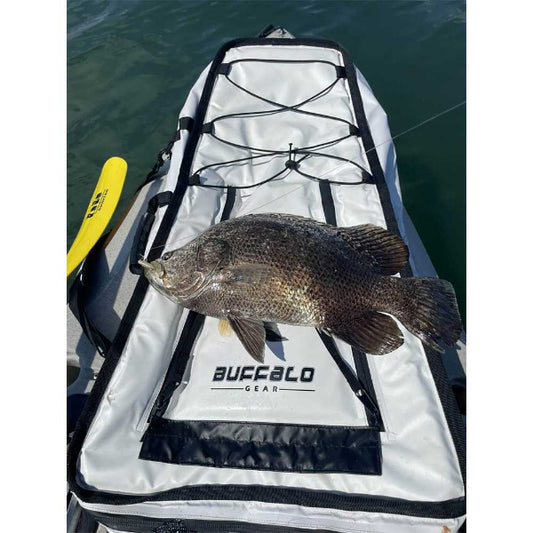 Fish on a Buffalo Gear paddleboard with water in the background