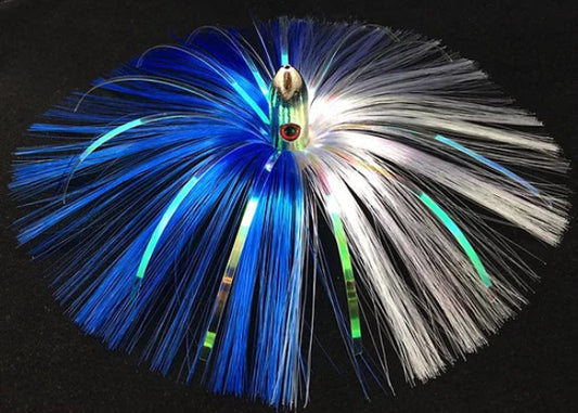 Fishing lure with blue and white fibers on a black background