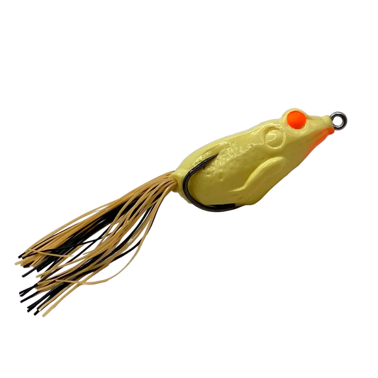 A frog-shaped fishing lure with a textured yellow body, bright orange eyes, and a skirt made of tan and black strands, shown on a plain white background.