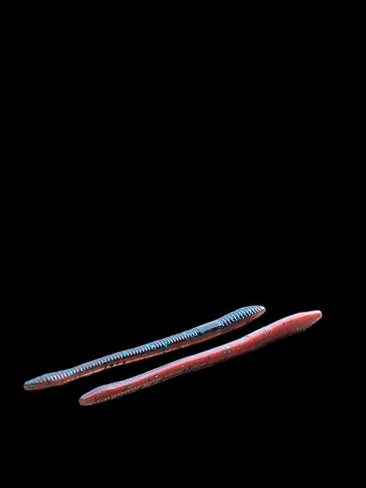 Two colorful sticks on a rock with a forest background