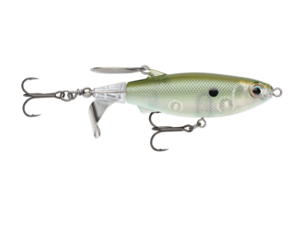 A fishing lure shaped like a small fish, shown from the side on a plain white background. The lure has a metallic olive-green and silver body with a clear plastic belly section, a black eye, and two silver treble hooks attached.