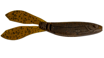 A soft plastic fishing lure shaped like a small fish with two paddle-like tails, shown on a plain white background. The body is dark brown with a scaled texture and small red glitter flecks, while the tails are translucent amber-brown with black speckles.