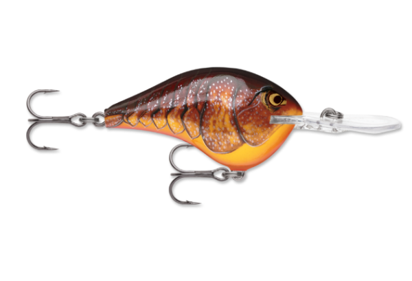 A dark brown and orange fishing lure with scale patterns and two treble hooks.