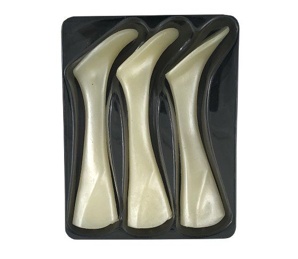 Four curved ivory-colored bone-shaped pieces arranged in a black plastic tray, photographed against a plain white background.