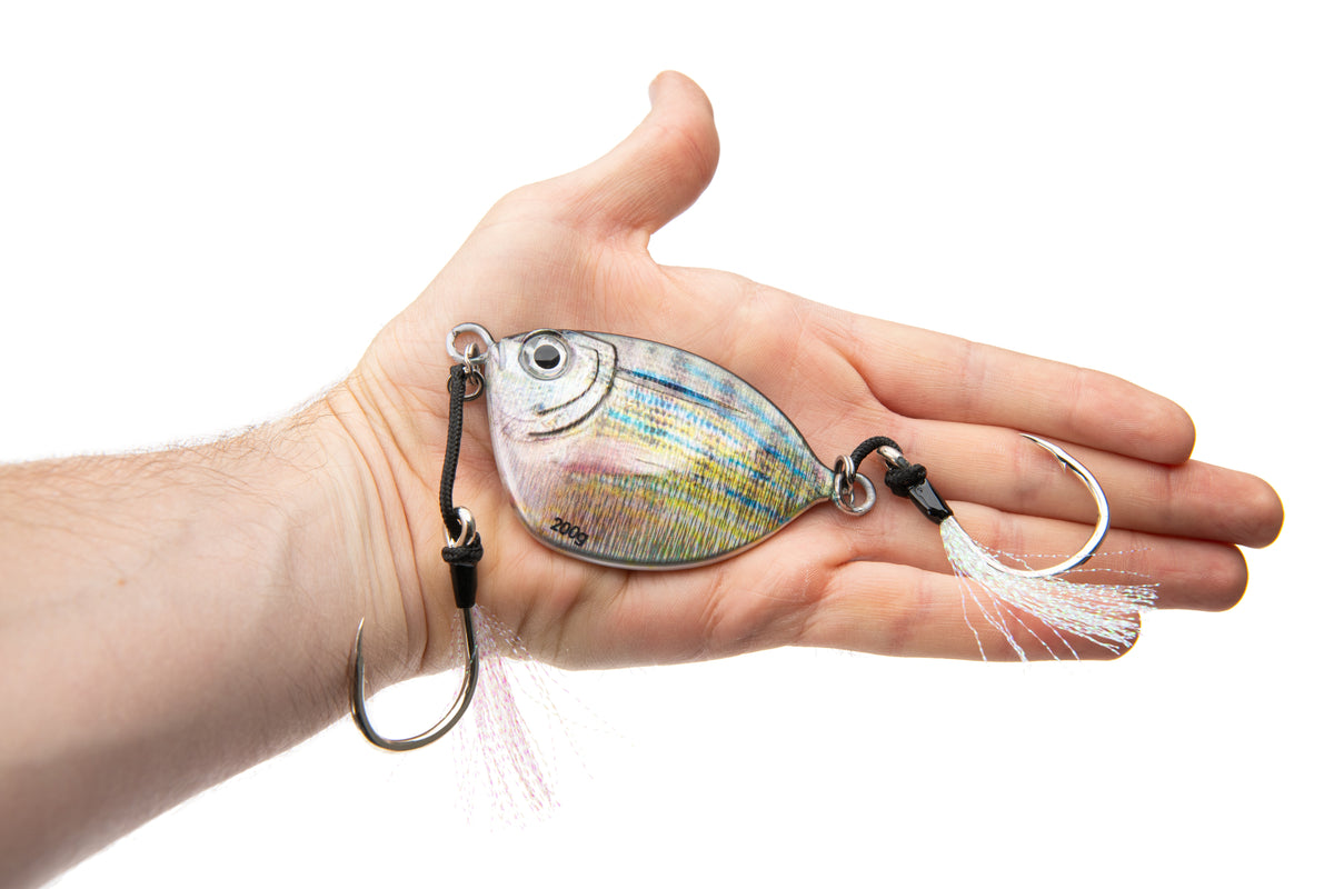 Fishing lure held in a hand on a white background