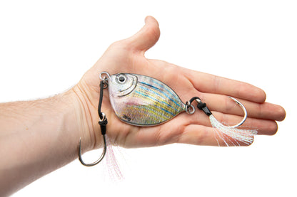 Fishing lure held in a hand on a white background