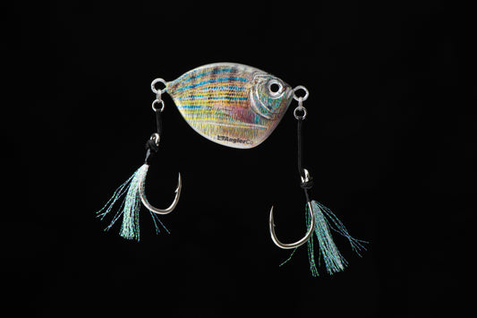 Fishing lure with a colorful body and blue tassels on a black background