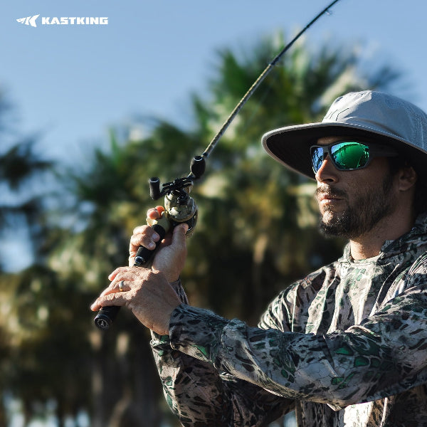 Man fishing with a rod, wearing sunglasses and a cap, with KastKing logo in the corner.