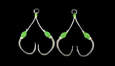 A pair of silver metal fishing hooks with white braided cords, bright green bead accents, and small silver rings at the top, displayed on a clean white background.