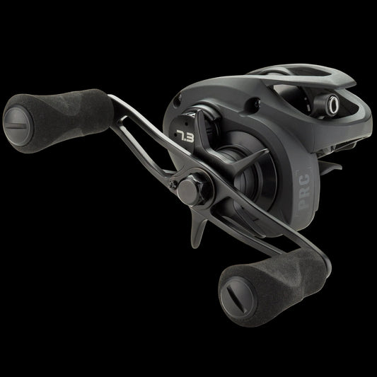 A black baitcasting fishing reel with dual foam handles, shown at a three-quarter angle on a clean white background. The reel features the '7.