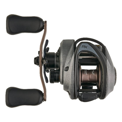 Dark grey low-profile fishing reel with bronze handle and prominent SX logo.