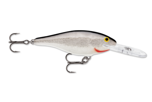 Silver fishing lure with black back, yellow eyes, red gill, and two treble hooks.