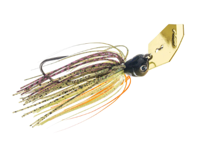 A fishing jig lure with a gold-colored metal blade, a black head, and multi-colored skirt strands in olive green, orange, and purple with black speckles, isolated on a white background.
