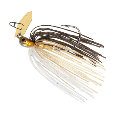 A fishing jig lure with a gold and orange head, a beige wing blade, dark brown and black skirt strands, and translucent white skirt strands on a plain white background.