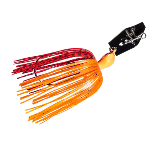 A fishing lure with a black top, silver metal hardware, and a skirt transitioning from red with black speckles to bright orange, shown on a plain white background.
