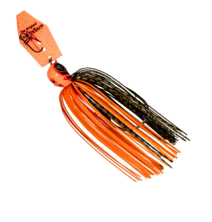 An orange and black paddle tail fishing lure with a bright orange tag attached, shown on a plain white background.
