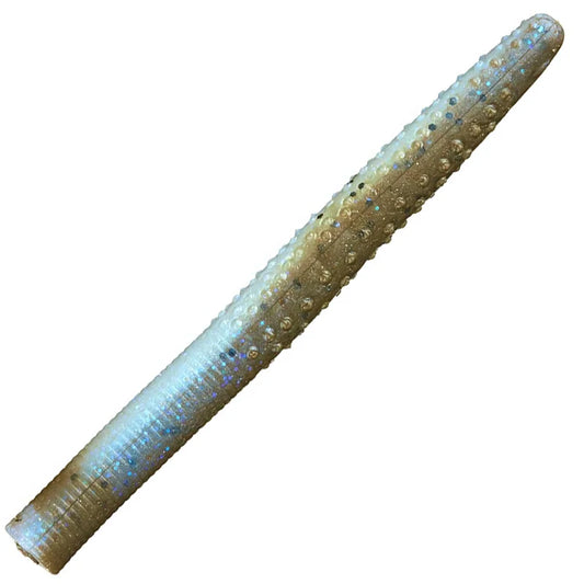 A single soft plastic fishing lure shaped like a small worm or tube, shown diagonally on a plain white background. The lure has a textured, bumpy surface with a color gradient shifting from iridescent light blue on one end to metallic gold and bronze on the other, with tiny reflective glitter details.