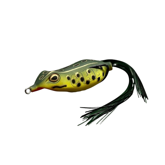 A frog-shaped fishing lure with a yellow-green body, black spots, a red mouth, and a dark green skirt with black strands, shown on a plain white background.