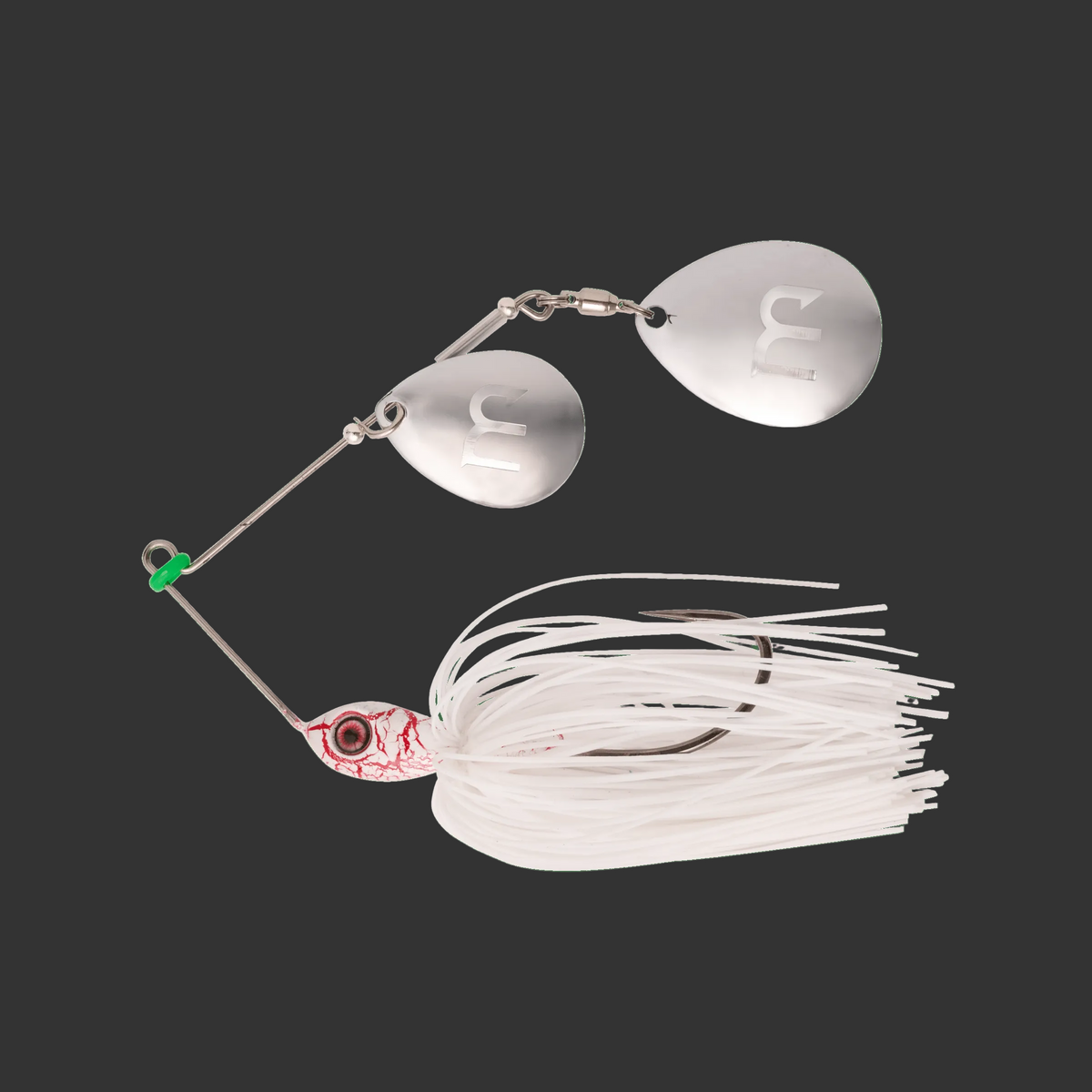 Fishing lure with metallic body and white skirt on a green background