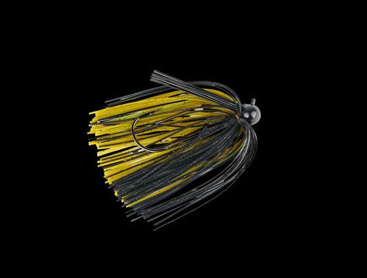 A single fishing jig head with a black and yellow skirt and black wire strands, photographed on a plain white background.