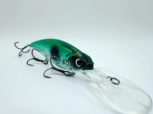 Fishing lure with a green and black body on a white background